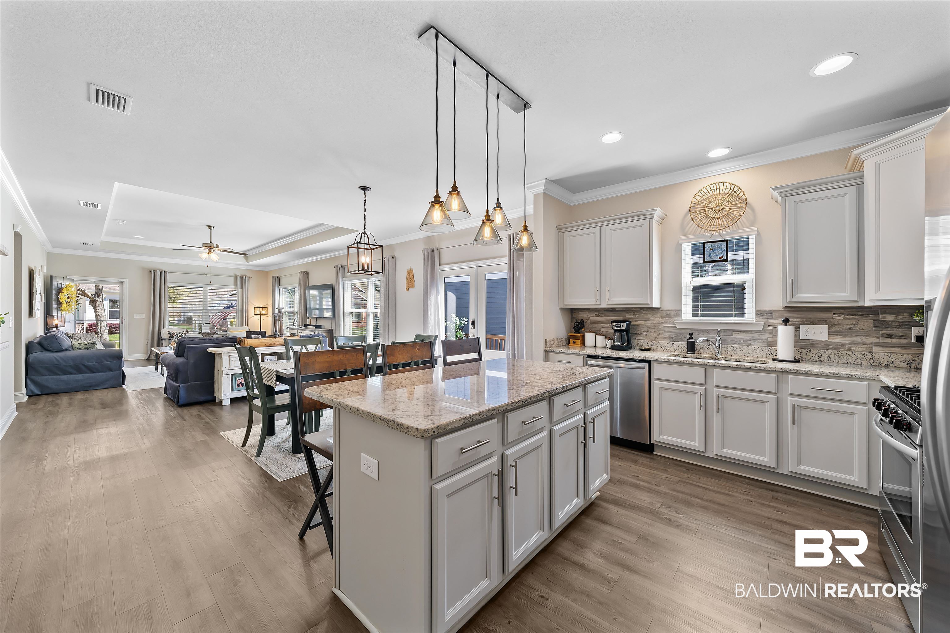 1221 Primrose Lane Foley, AL 36535 - Photo 26 of 29 Kitchen featuring visible vents, a kitchen bar, a tray ceiling, appliances with stainless steel finishes, and a sink