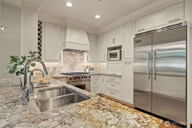 a kitchen with a refrigerator sink and stove