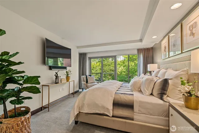 a bedroom with a bed mirror and window