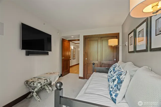 a bedroom with a bed and a flat screen tv