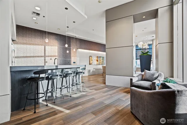 a living room with furniture and wooden floor