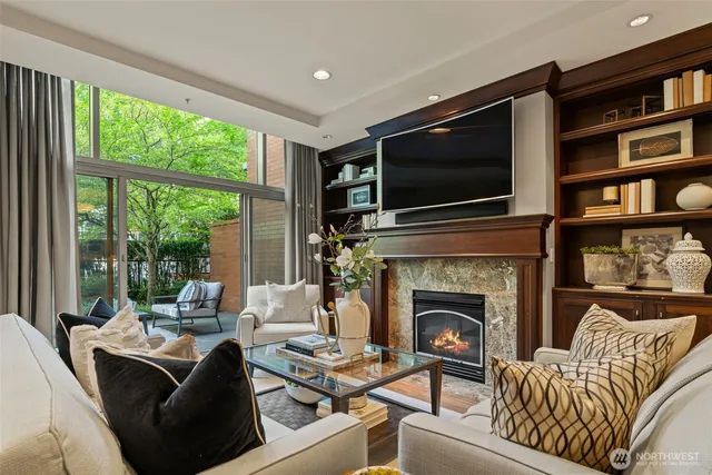 a living room with furniture a flat screen tv and a fireplace