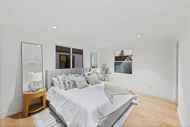 a spacious bedroom with a bed and a couch