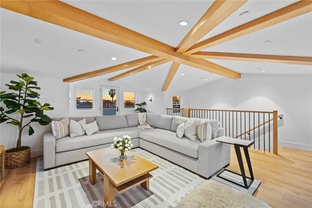 a living room with furniture a rug and a ceiling fan