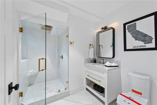 a bathroom with a double vanity sink mirror and shower