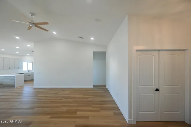a view of a hallway with wooden floor
