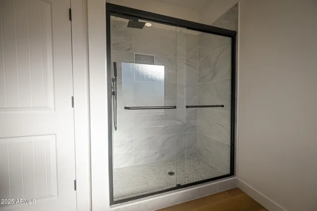 a bathroom with a glass shower door