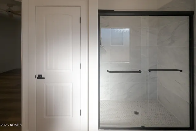 a bathroom with a glass shower door