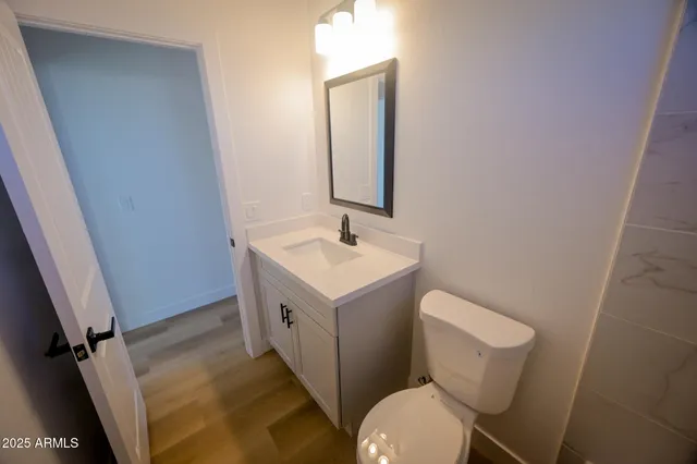 a bathroom with a toilet sink and mirror