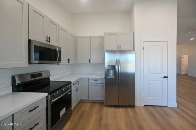 a kitchen with a refrigerator stove and microwave
