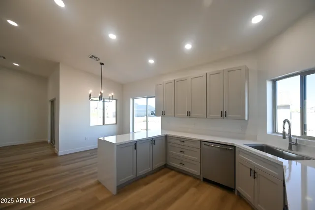 a kitchen with sink cabinets and window