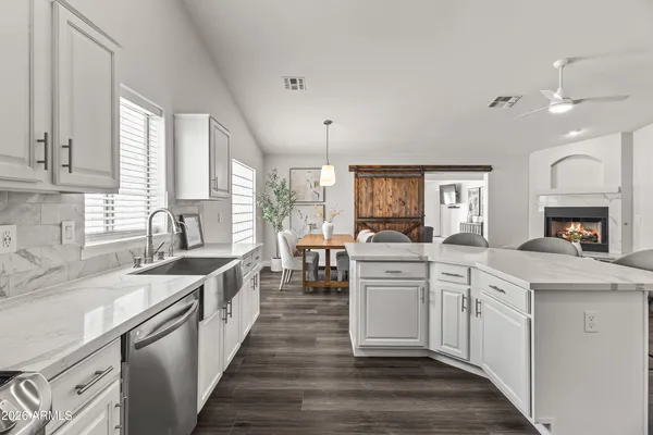 a kitchen with white cabinets and white appliances