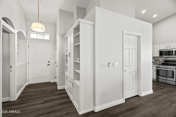 a view of a hallway with wooden floor and windows