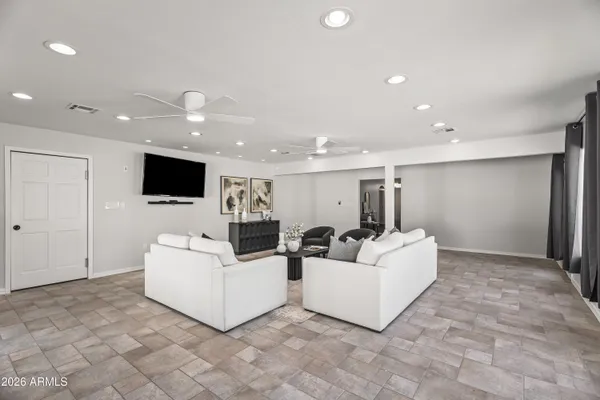 a living room with furniture and a flat screen tv