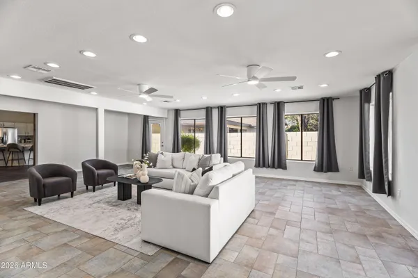 a living room with furniture and large windows