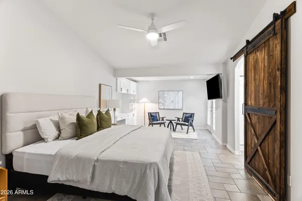 a bed room with a bed and a chair