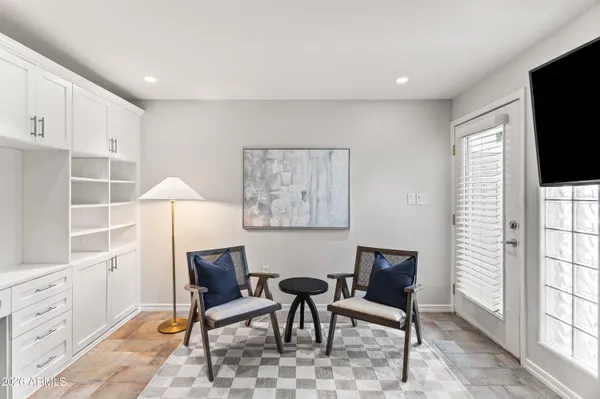 a view of a livingroom with furniture and a flat screen tv