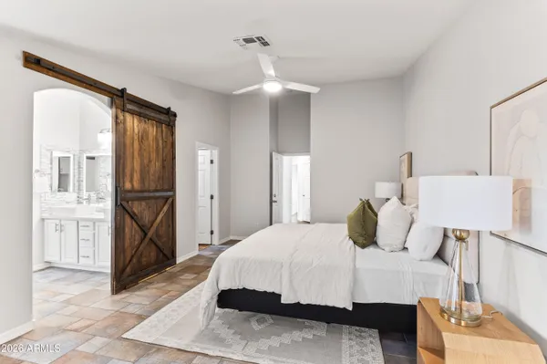 a bedroom with a bed and a chandelier