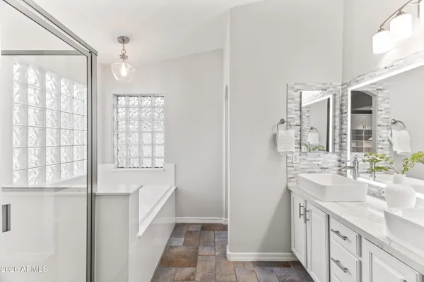 a bathroom with a double vanity sink and a bathtub
