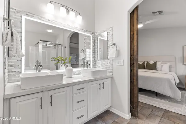 a en suite bathroom with a double vanity sink and a mirror