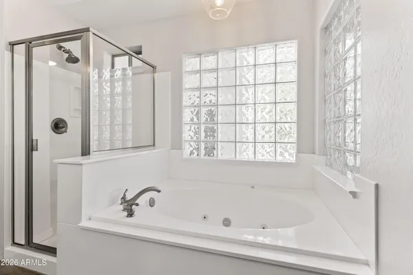 a bathroom with a bathtub and a shower