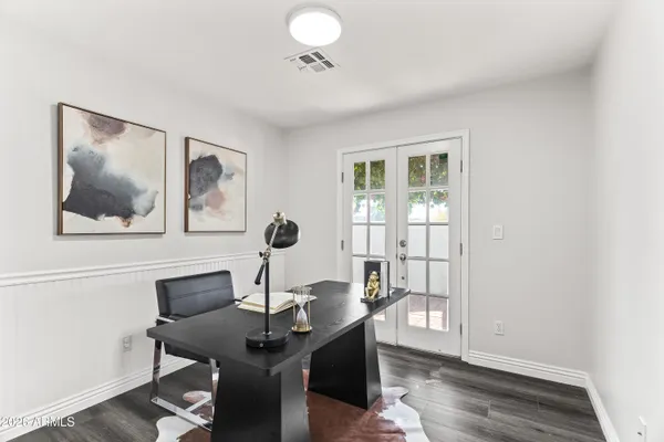 a view of a workspace with furniture and wooden floor