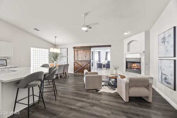 a living room with fireplace furniture and a wooden floor