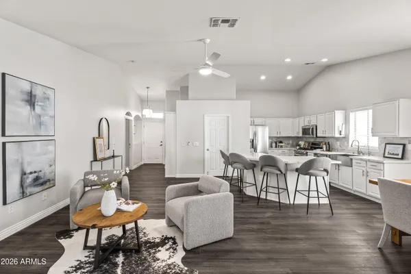 a living room with furniture kitchen view and a dining table