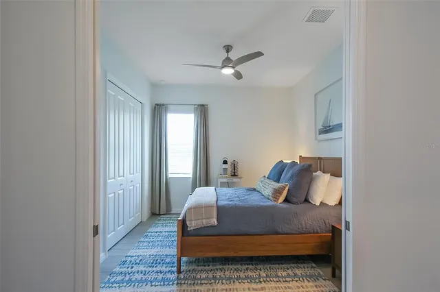 a bedroom with a bed and wooden floor