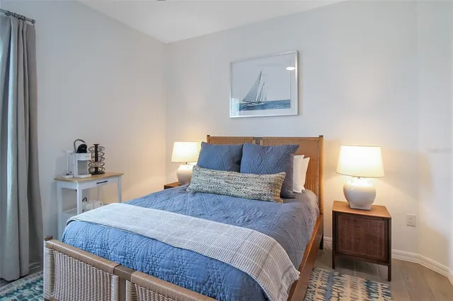 a bedroom with a bed and a large mirror