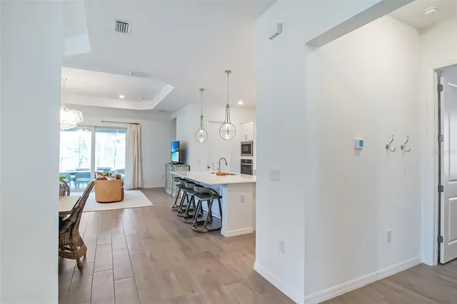a view of a hallway with wooden floor