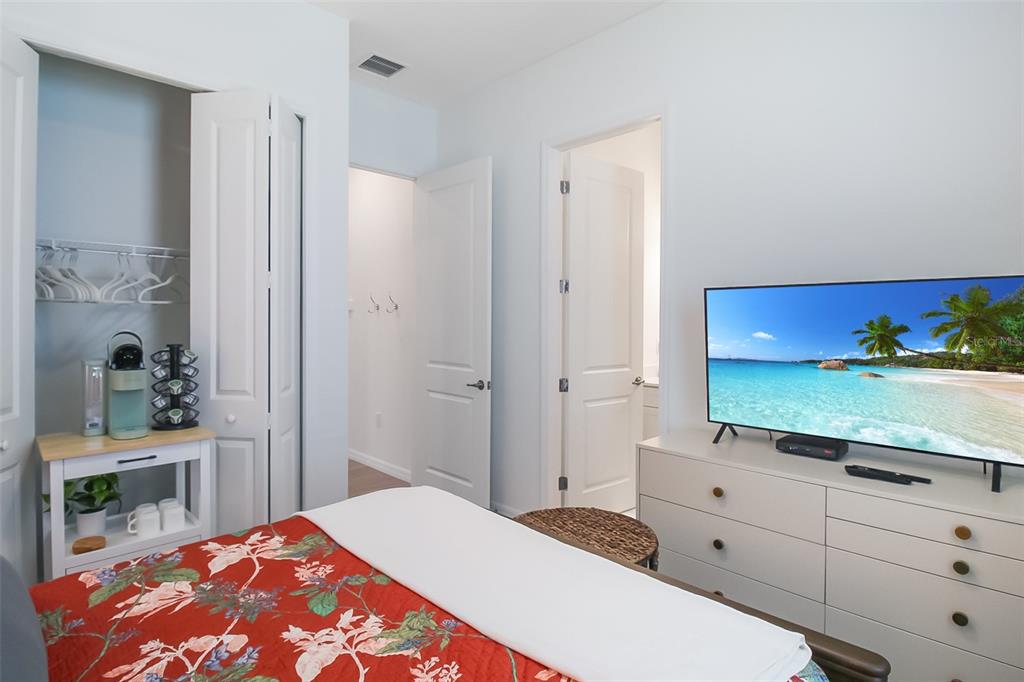 17335 Jadestone Court Venice, FL 34293 - Photo 19 of 54 a bedroom with a bed and a dresser in it