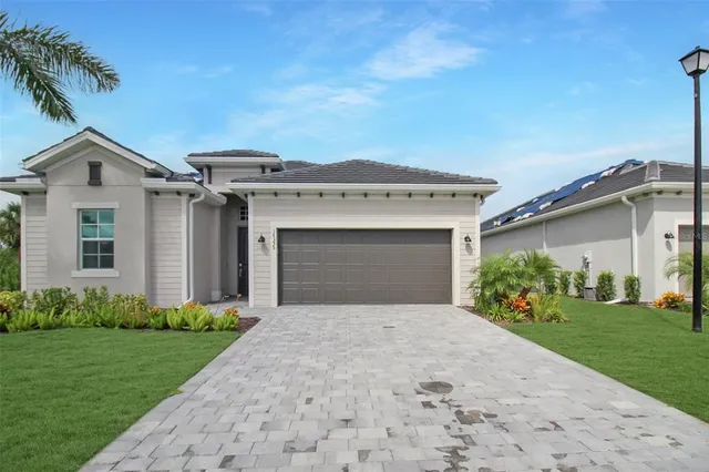 a front view of a house with a garden and yard