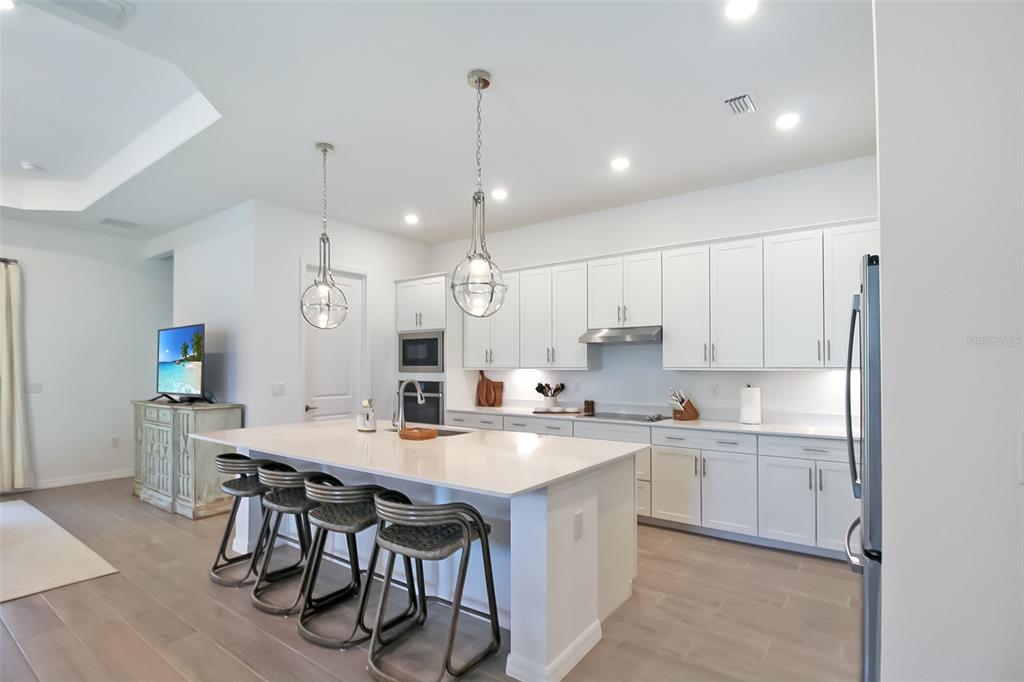 17335 Jadestone Court Venice, FL 34293 - Photo 24 of 54 a kitchen with a sink a center island a counter space and a window