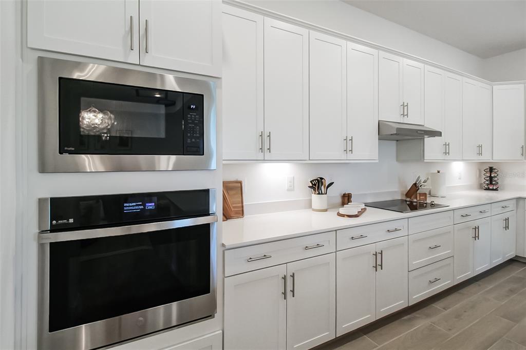17335 Jadestone Court Venice, FL 34293 - Photo 29 of 54 a kitchen with granite countertop white cabinets and stainless steel appliances