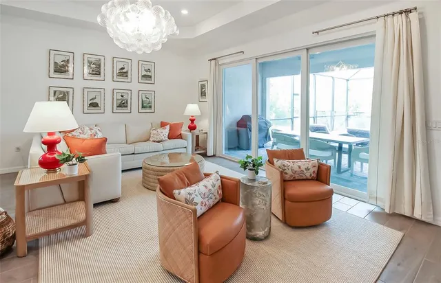a living room with furniture and a chandelier