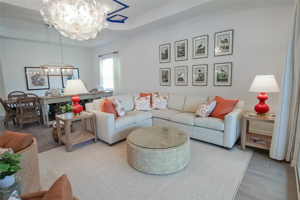 17335 Jadestone Court Venice, FL 34293 - Photo 33 of 54 a living room with furniture and a chandelier