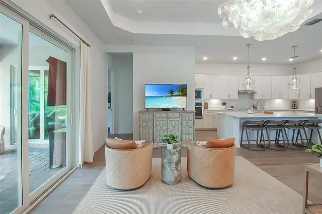 a bedroom with a bed a mirror on dresser and a window