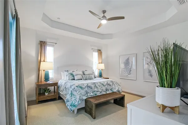 a bedroom with a bed window and mirror