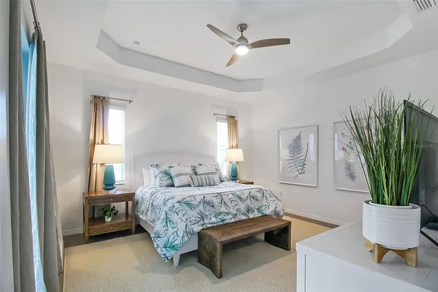 a bedroom with a bed window and mirror