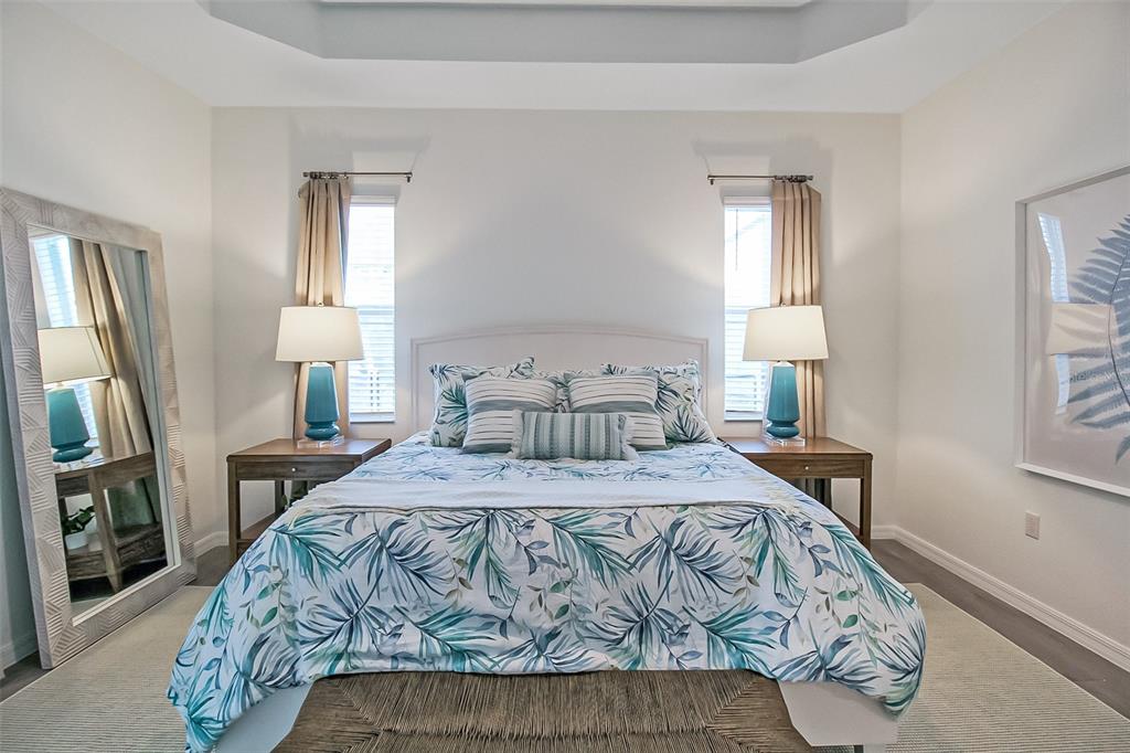 17335 Jadestone Court Venice, FL 34293 - Photo 36 of 54 a bedroom with a bed a mirror on dresser and a window