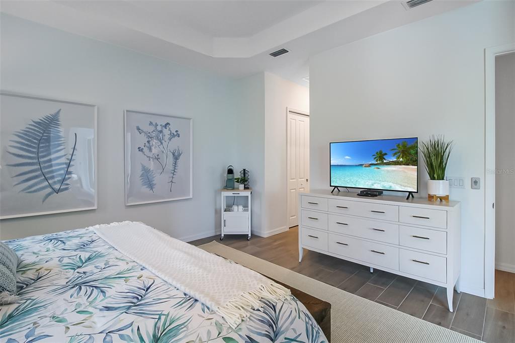 17335 Jadestone Court Venice, FL 34293 - Photo 37 of 54 a bedroom with a bed window and mirror