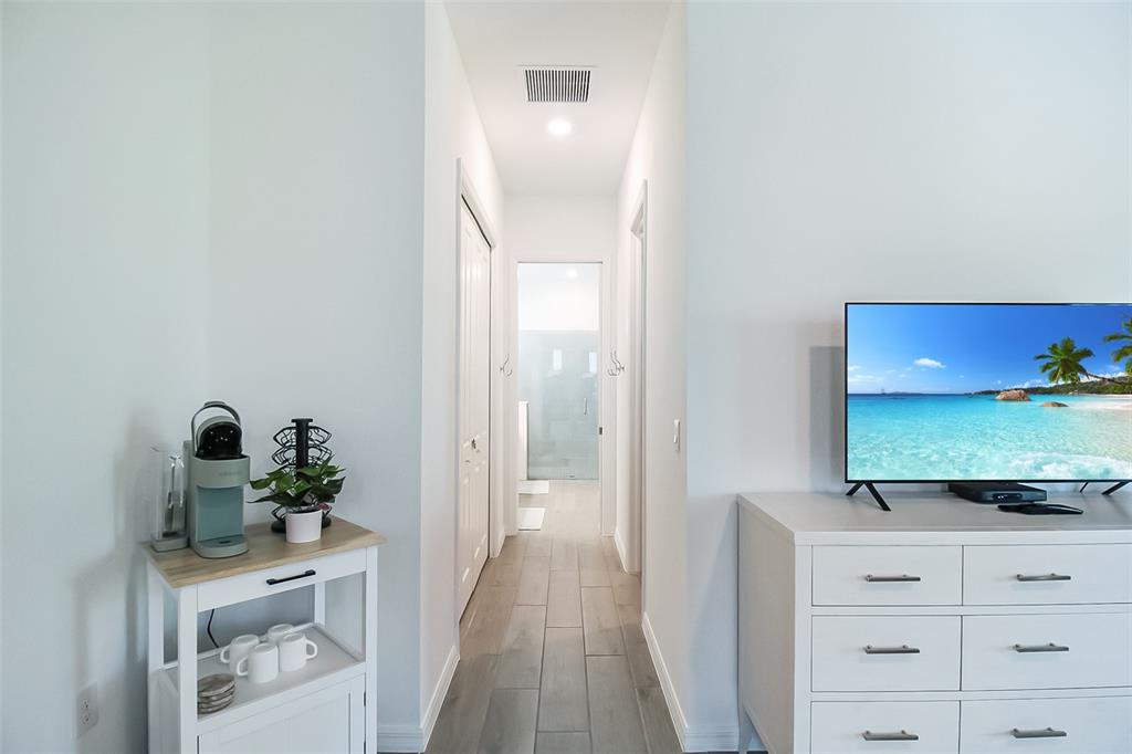 17335 Jadestone Court Venice, FL 34293 - Photo 39 of 54 a view of a hallway to a livingroom and a couch