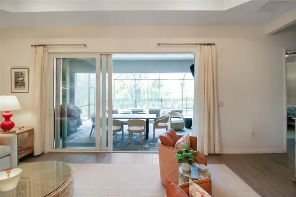 a living room with furniture a flat screen tv and a window