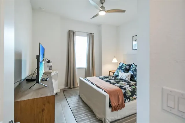 a bed sitting in a bedroom and next to a window