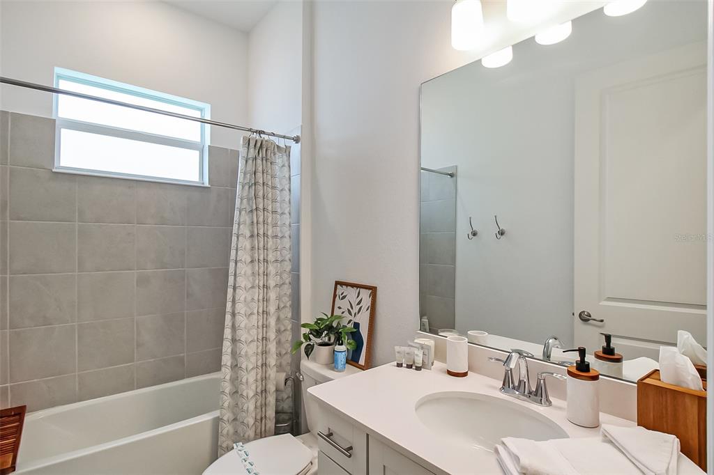 17335 Jadestone Court Venice, FL 34293 - Photo 10 of 54 a bathroom with a sink a toilet a mirror and shower