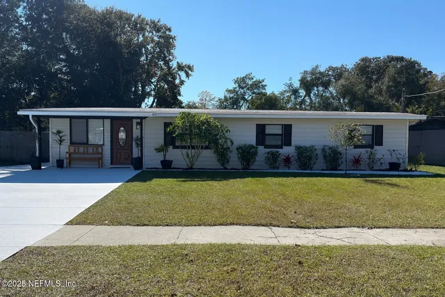 a front view of house with yard and outdoor seating