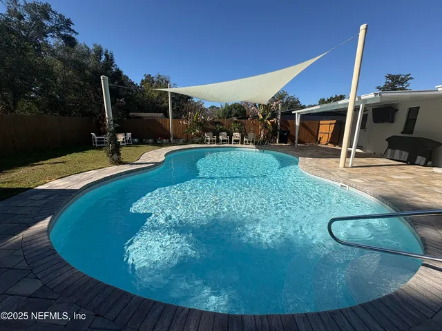 a view of a swimming pool with a patio