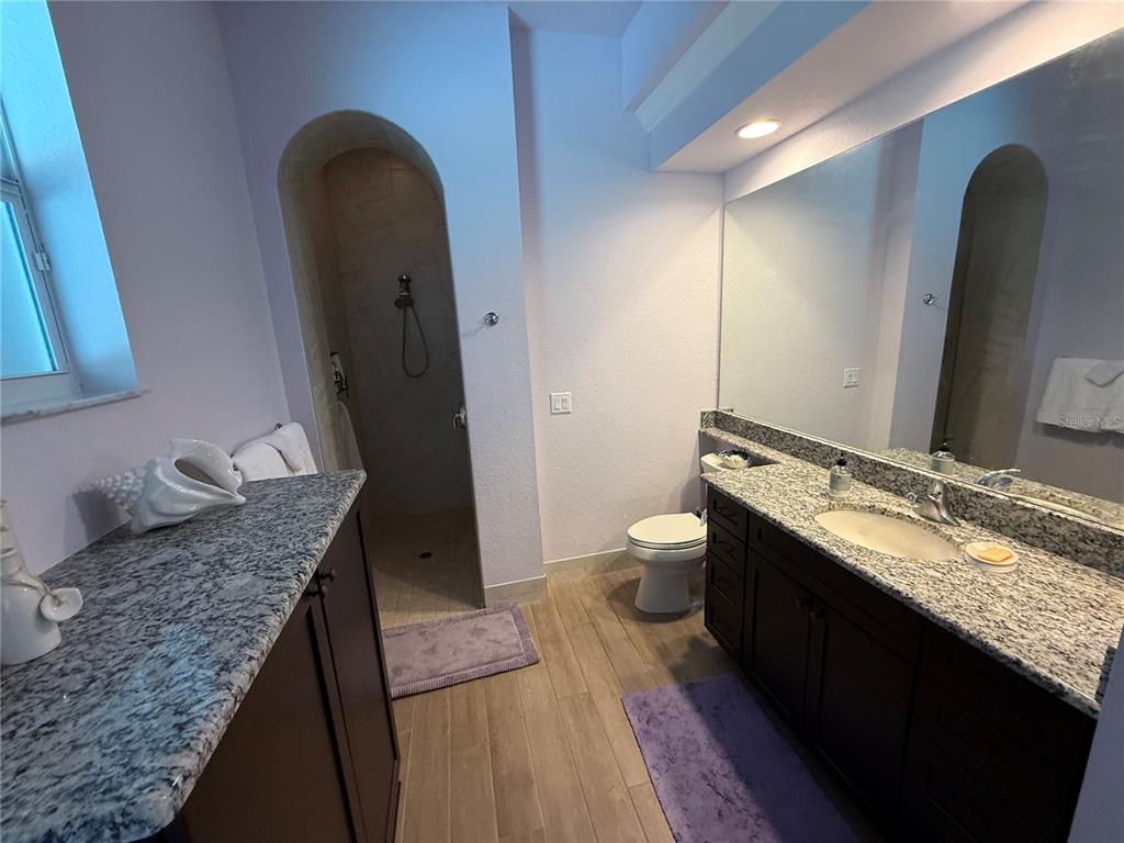 13110 Bamboo Street Spring Hill, FL 34609 - Photo 31 of 56 a bathroom with a granite countertop sink and a mirror