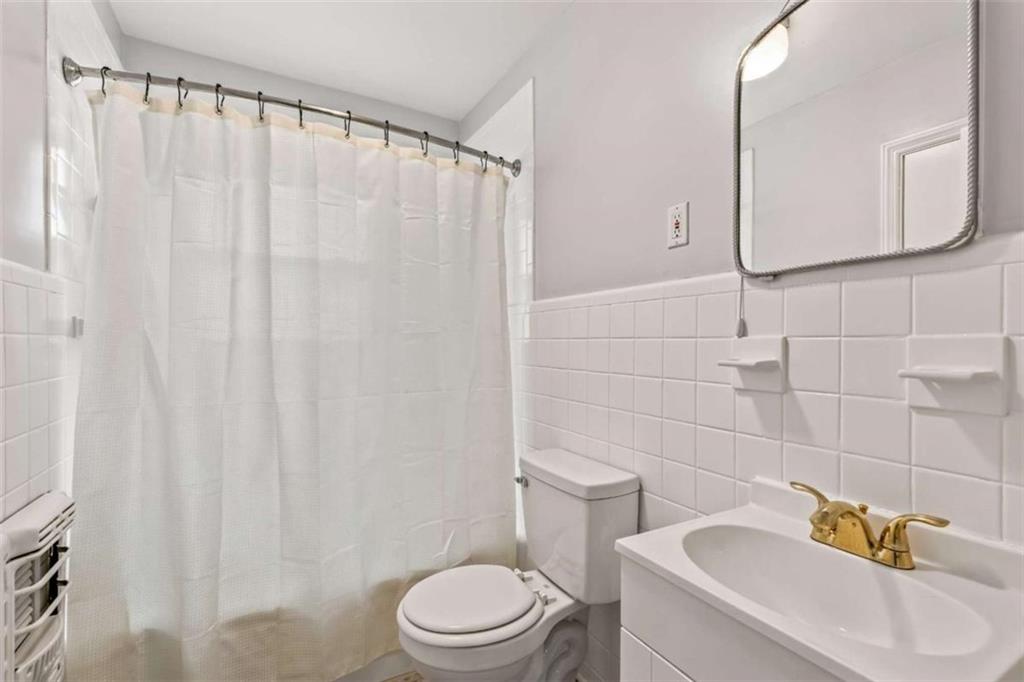 1780 John Calvin Avenue, Unit R College Park, GA 30337 - Photo 7 of 12 a white toilet sitting next to a bathroom sink